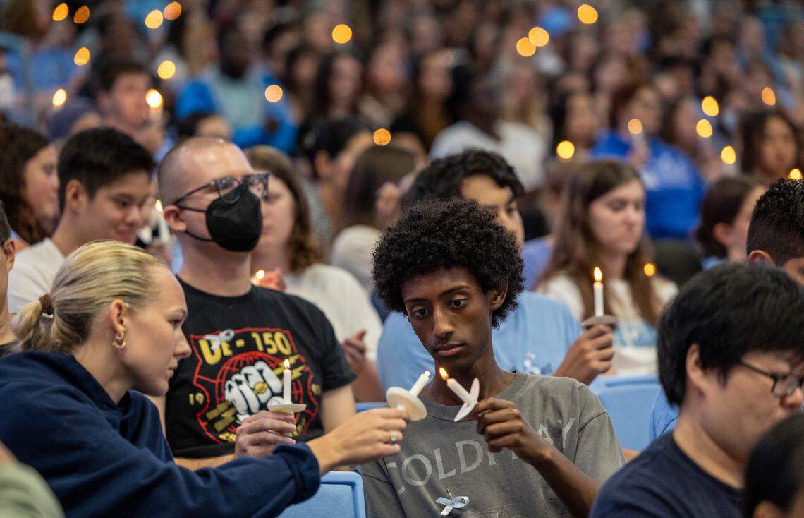 UNC-Chapel Hill students, faculty and family hold a candle light vigil Friday, Aug 30, 2023 at the Dean Smith Center in honor of professor Zijie Yan who was shot and killed on campus on Monday.