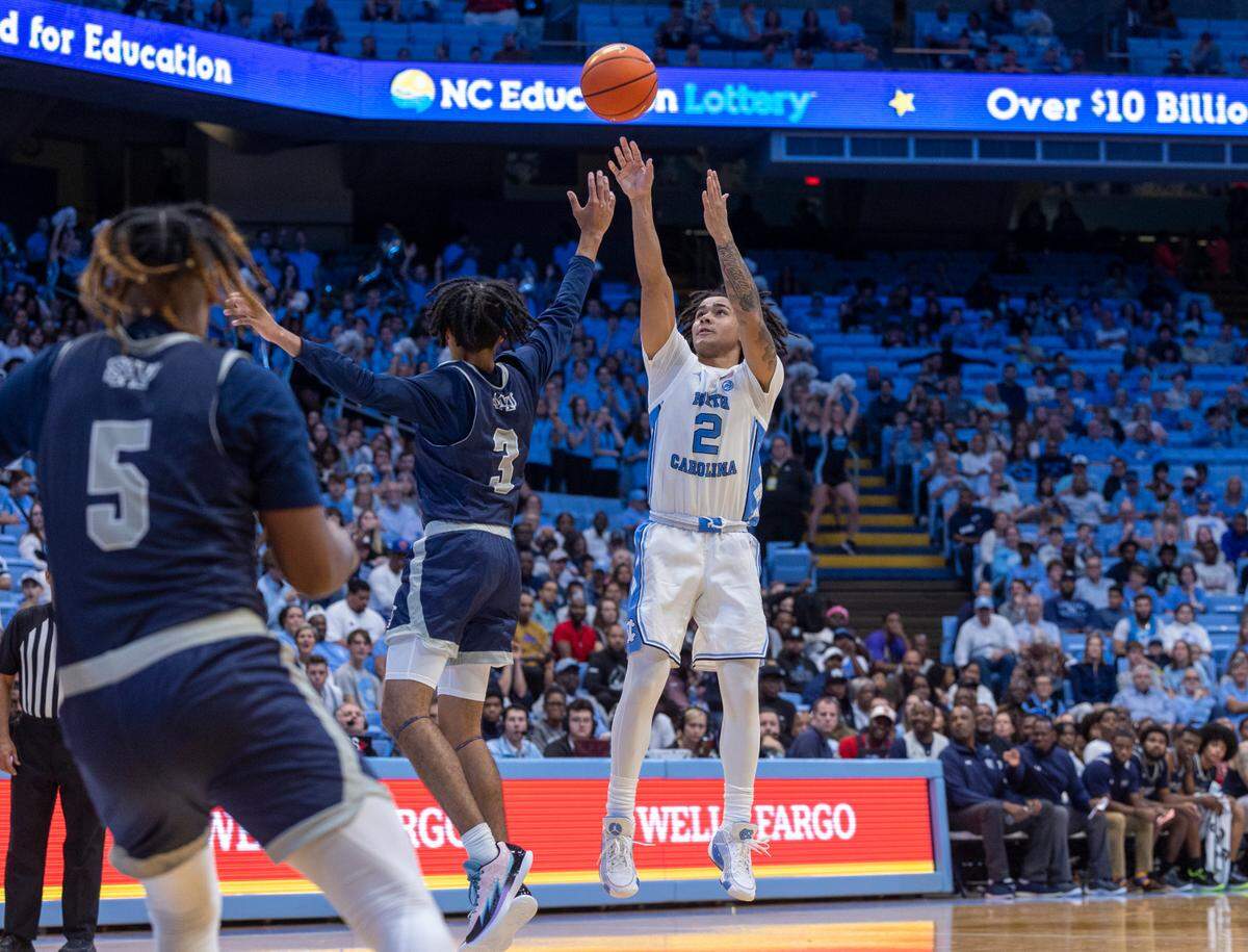 North Carolina’s Elliott Cadeau (2) launches a three-point attempt against St. Augustine’s D’dric Rogers (3) in the second half on Friday, October 27, 2023 at the Smith Center in Chapel Hill, N.C.