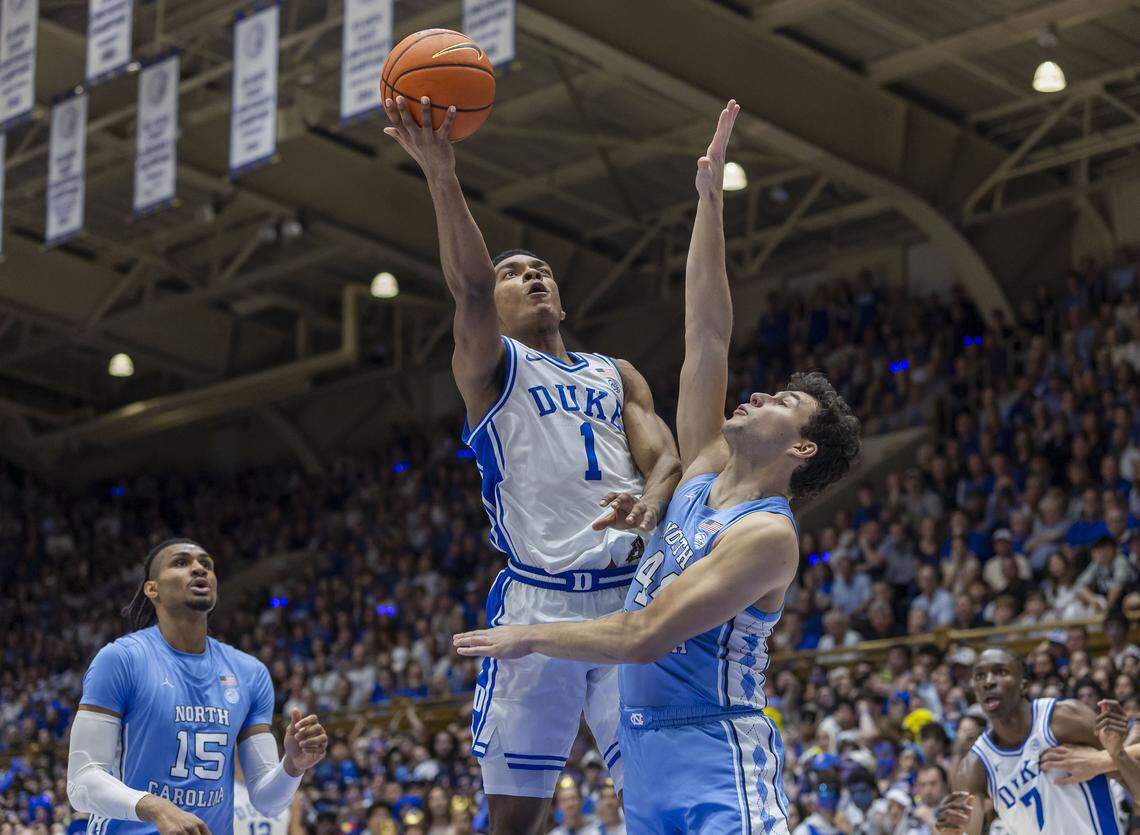 Duke guard Caleb Foster (1)  drives to the basket against North Carolina guard Luka Bogavac (44) in the first half on Saturday, March 7, 2026 at Cameron Indoor Stadium in Durham, N.C.
