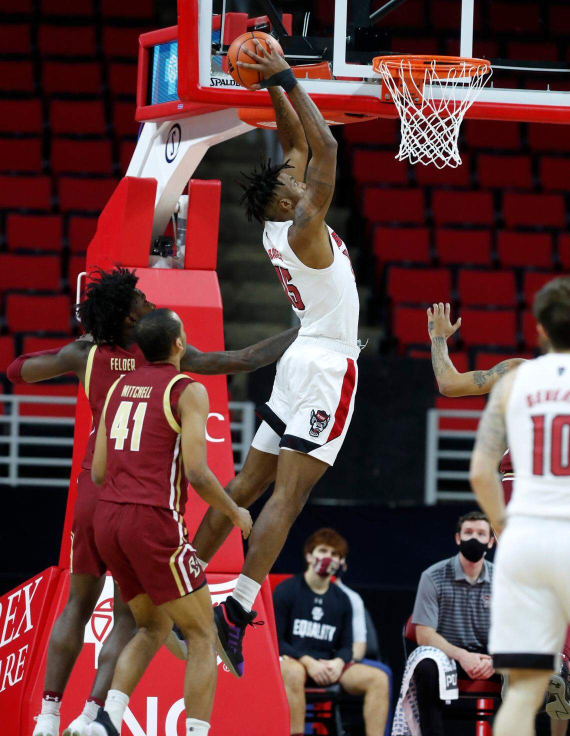 N.C. State’s Manny Bates (15) heads to slam in two during the first half of N.C. State’s game against Boston College at PNC Arena in Raleigh, N.C., Wednesday, December 30, 2020.