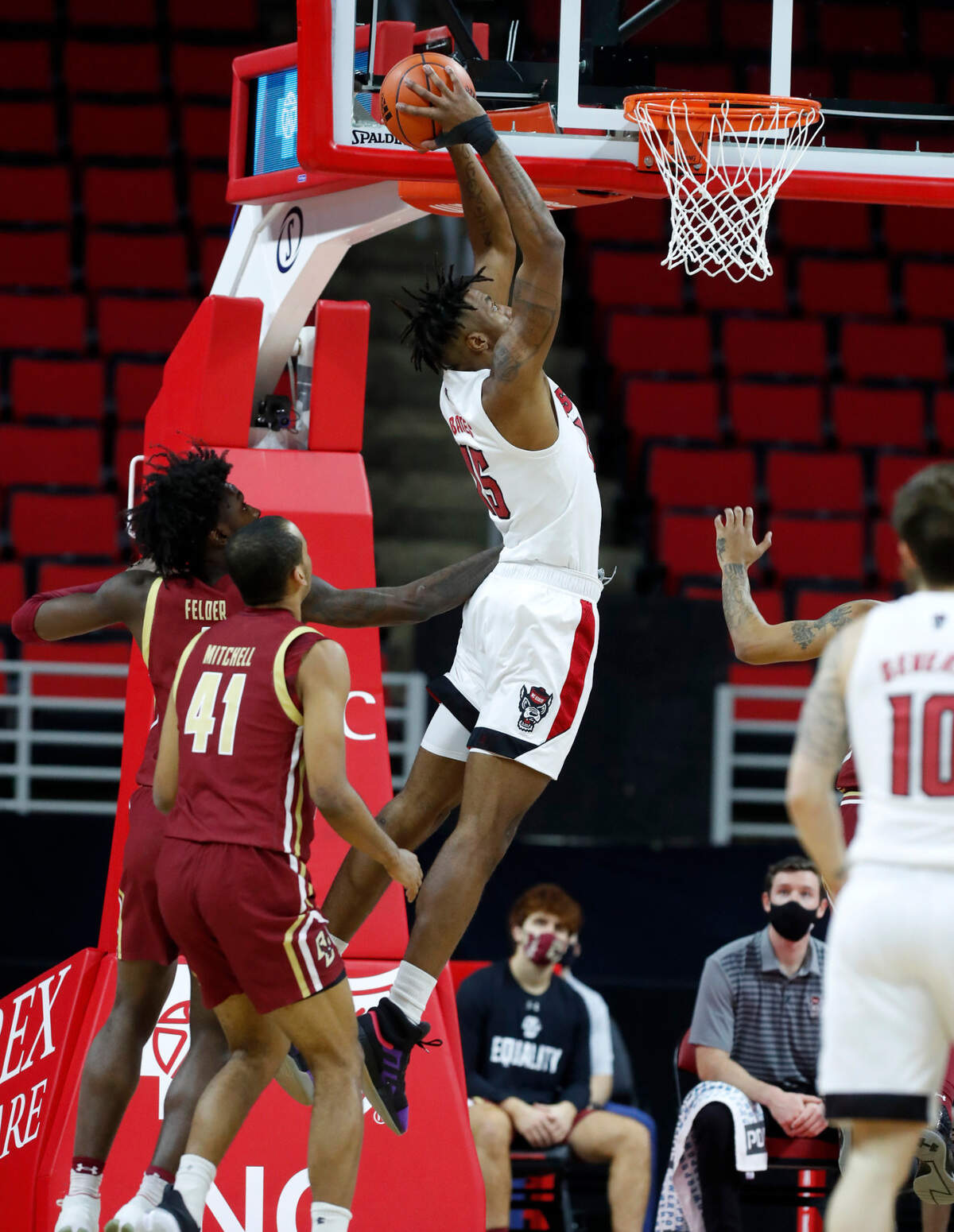 N.C. State’s Manny Bates (15) heads to slam in two during the first half of N.C. State’s game against Boston College at PNC Arena in Raleigh, N.C., Wednesday, December 30, 2020.