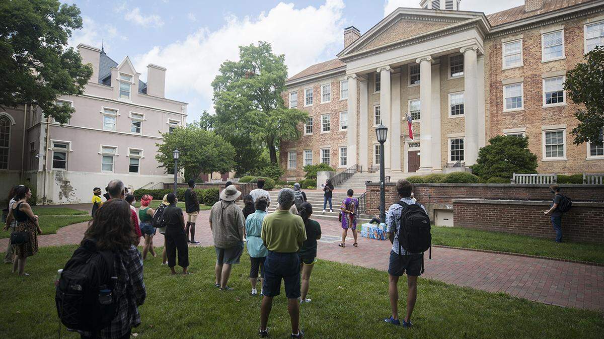 A small crowd of UNC-Chapel Hill students and staff gather outside South Building in Chapel Hill, N.C. for a demonstration, put on by the UNC chapter of the NAACP on Monday, July 12, 2021, in solidarity with students who protested a recent board of trustees meeting.