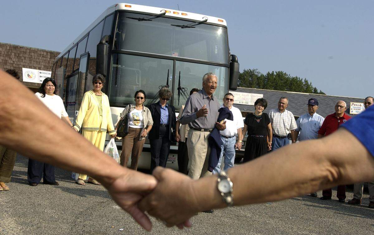 Rev. Welton Lowry, center, leads the group in prayer before boarding the bus to leave for Washington DC from Pembroke in 2003. Members of the Lumbee tribe traveled there to show support for giving the tribe official recognition, something that has been denied them for decades.