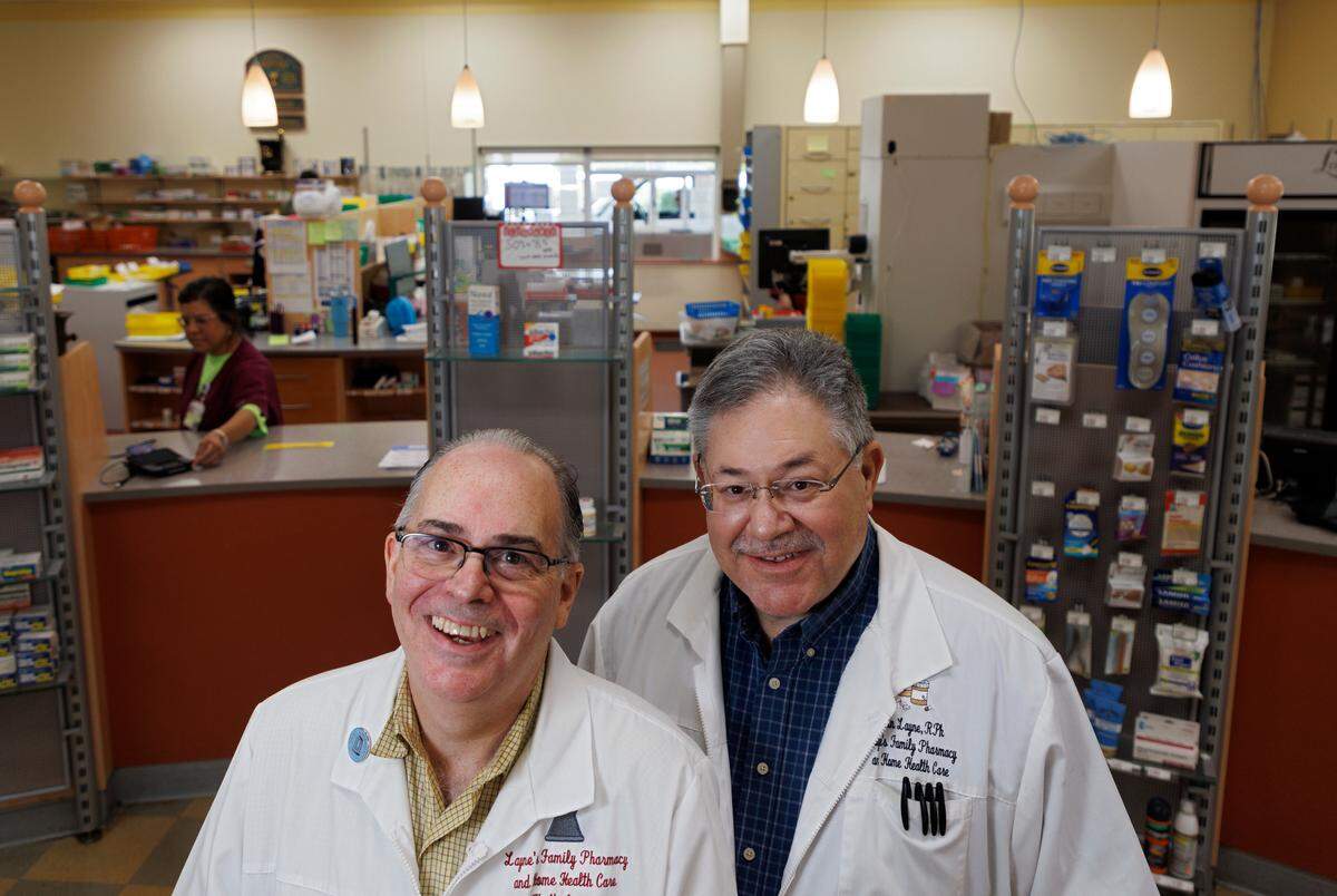 Pharmacists Keith and Kevin Layne, twin brothers and founders of Layne’s Family Pharmacy, are photographed on Wednesday, Aug. 14, 2024, in Eden, N.C.