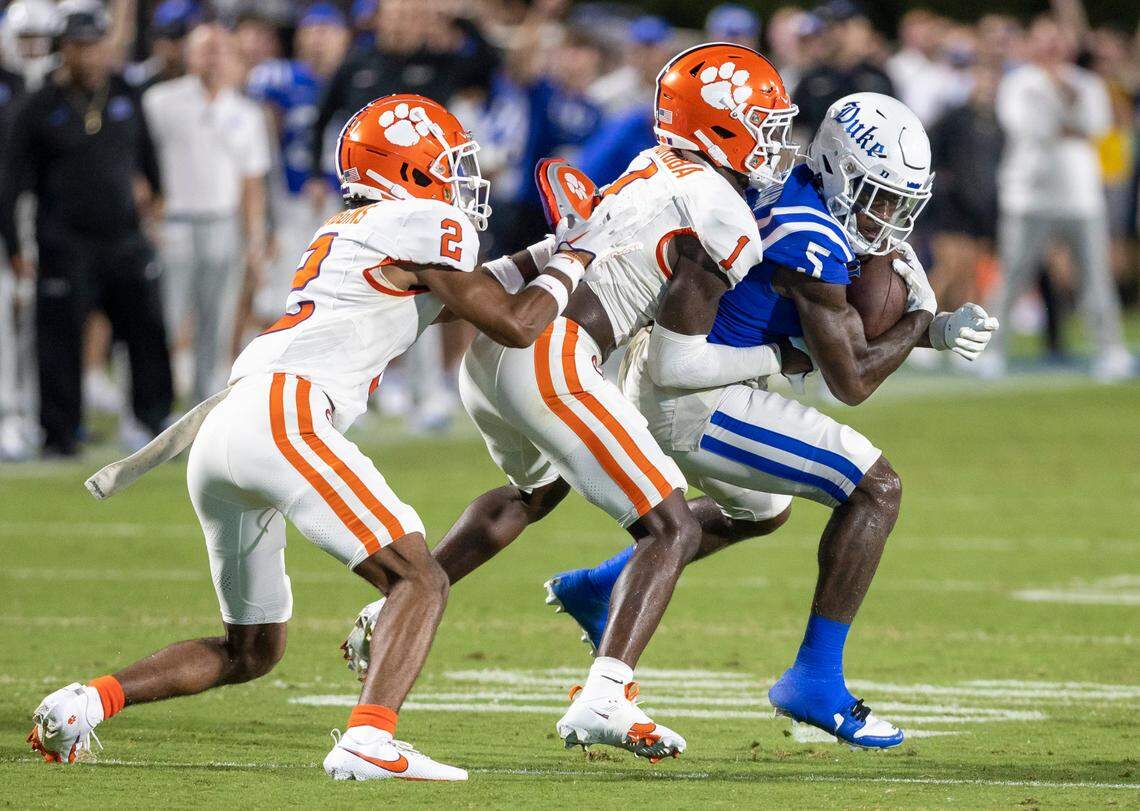 Clemson’s Nate Wiggins (2) and Andrew Mukuba (1) work to stop Duke receiver Jalon Calhoun (5) after a pass from quarterback Riley Leonard for a 10-yard gain in the first quarter on Monday, September 4, 2023 at Wallace Wade Stadium Stadium in Durham, N.C.