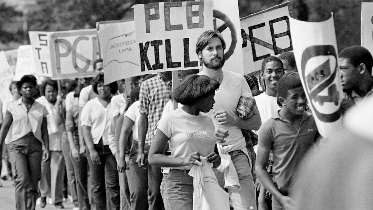 Protesters march in Warren County, NC in 1982 after a landfill for PCBs was placed near the community of Afton. Trucks belonging to the Ward Transformer Company deliberately released toxic chemicals called PCBs along 250 miles of North Carolina roadways. Once uncovered, the waste had to be collected and contained.