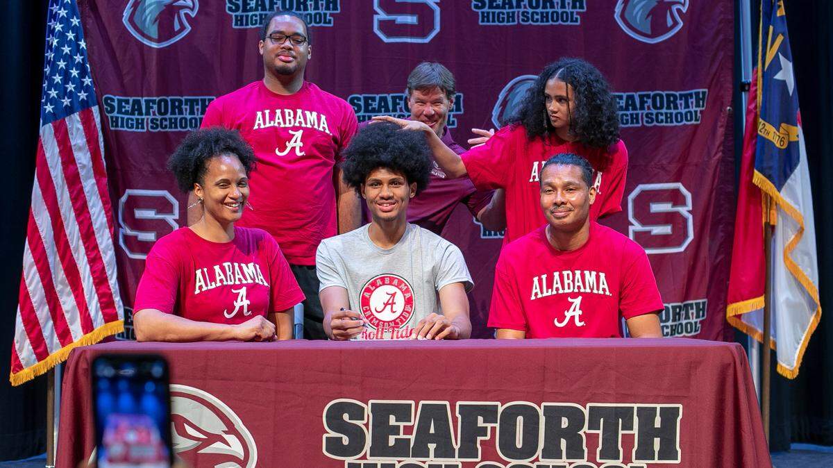 Naomi Stevenson plays with her brother Jarin Stevenson’s hair during a photo shoot with her family and athletic director Jason Amy at Seaforth High School in Pittsboro, N.C. on Tuesday June 27, 2023. It was Jarin Stevenson’s last visit to his high school, and Amy wanted a record of the event with Stevenson being the first athlete from Seaforth to sign with a college athletic program