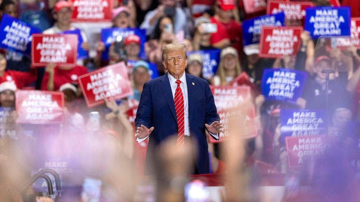 Former President Donald Trump, the Republican presidential nominee, soaks up applause from his supporters as he arrives for a rally on Wednesday, October 30, 2024 at the Rocky Mount Event Center in Rocky Mount, N.C.