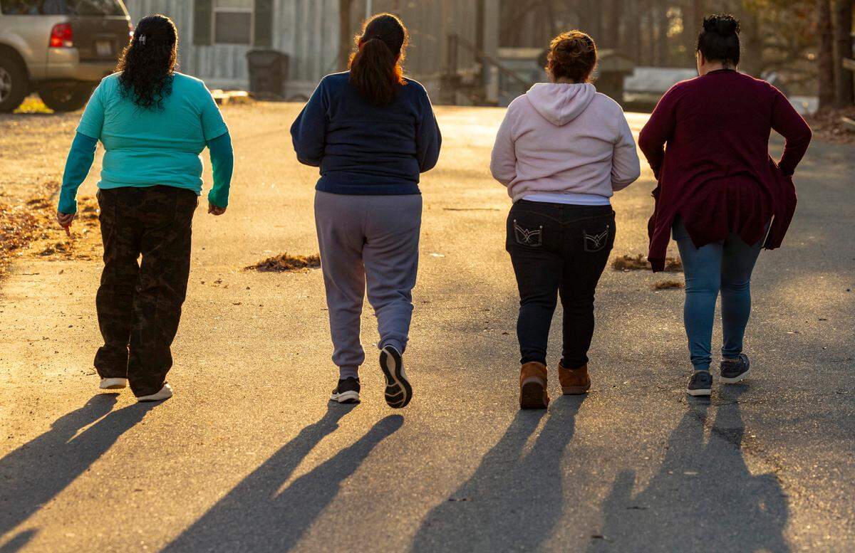 From left, Reyna, 41, Beatriz, 47, Sylvia, 49, and Ana, 47, all in the U.S. without permission, walk in their neighborhood in Durham.