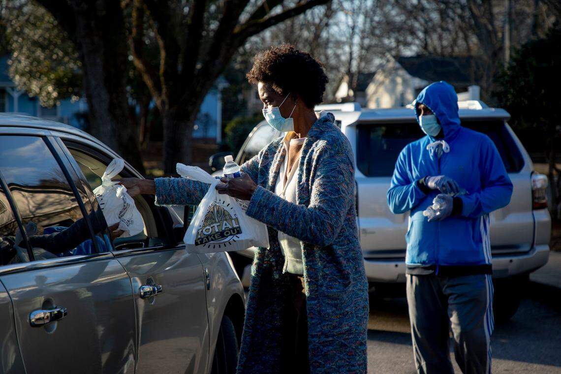 Spring Council distributes plates of hot food cooked by her late mother’s restaurant, Mama Dip’s Kitchen at a hunger relief in the Chapel Hill community, at Hargraves Community Center, on Wednesday, Jan. 6, 2021, in Chapel Hill, N.C.