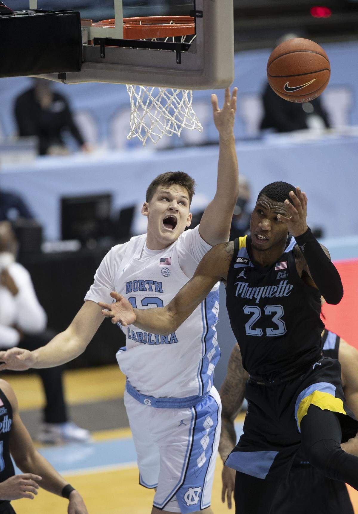 North Carolina’s Walker Kessler (13) and Marquette’s Jamal Cain (23) battle for a rebound during the second half on Wednesday, February 24, 2021 at the Smith Center in Chapel Hill, N.C.