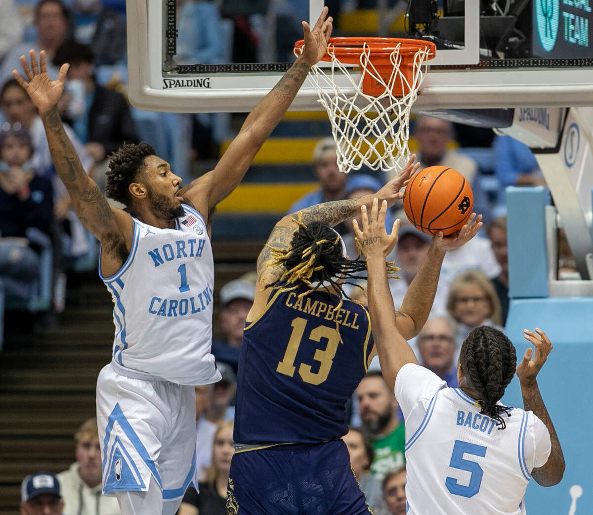 North Carolina’s Leaky Black (1) and Armando Bacot (5) defend Notre Dame’s Dom Campbell (13) in the second half on Saturday, January 7, 2023 at the Smith Center in Chapel Hill, N.C.