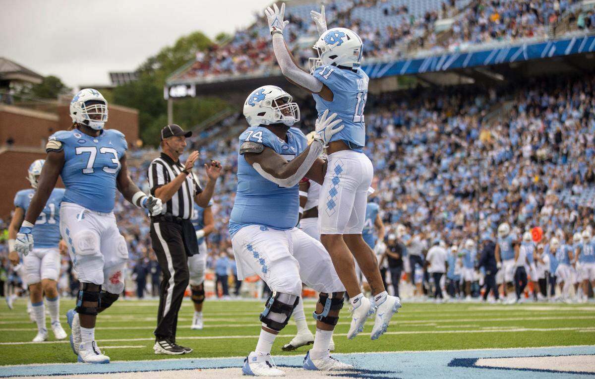 North Carolina’s Josh Downs (11) celebrates after scoring on a 33-yard pass reception from quarterback Sam Howell in the first quarter against Florida State on Saturday, October 9, 2021at Kenan Stadium in Chapel Hill, N.C.