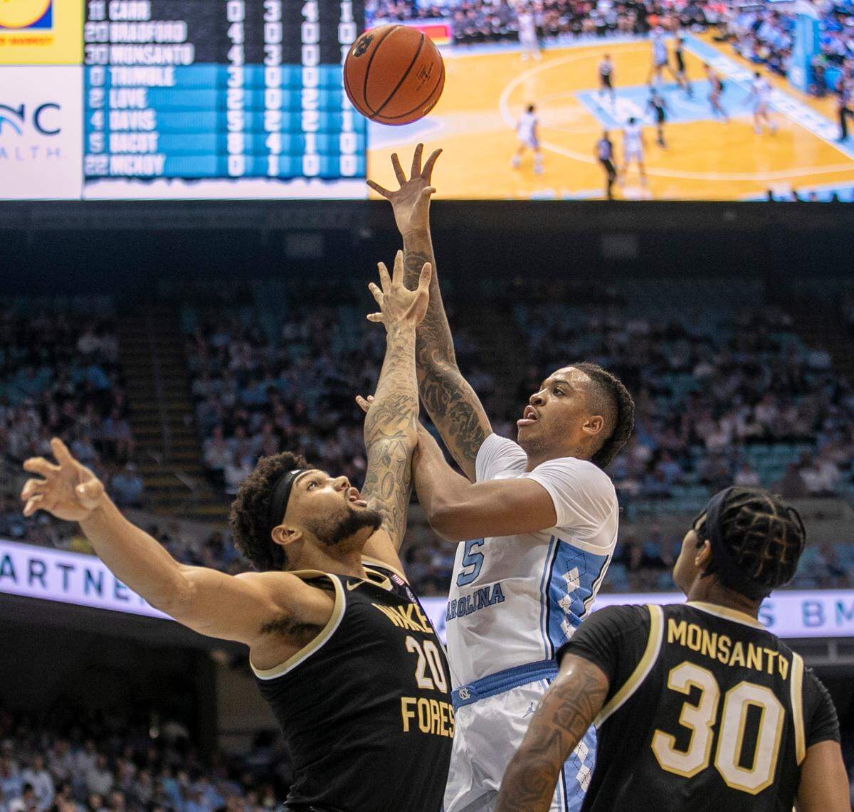 North Carolina’s Armando Bacot (5) puts up a shot against Wake Forest’s Davion Bradford (20) and Damari Monsanto (30) in the first half on Wednesday, January 4, 2023 at the Smith Center in Chapel Hill, N.C.