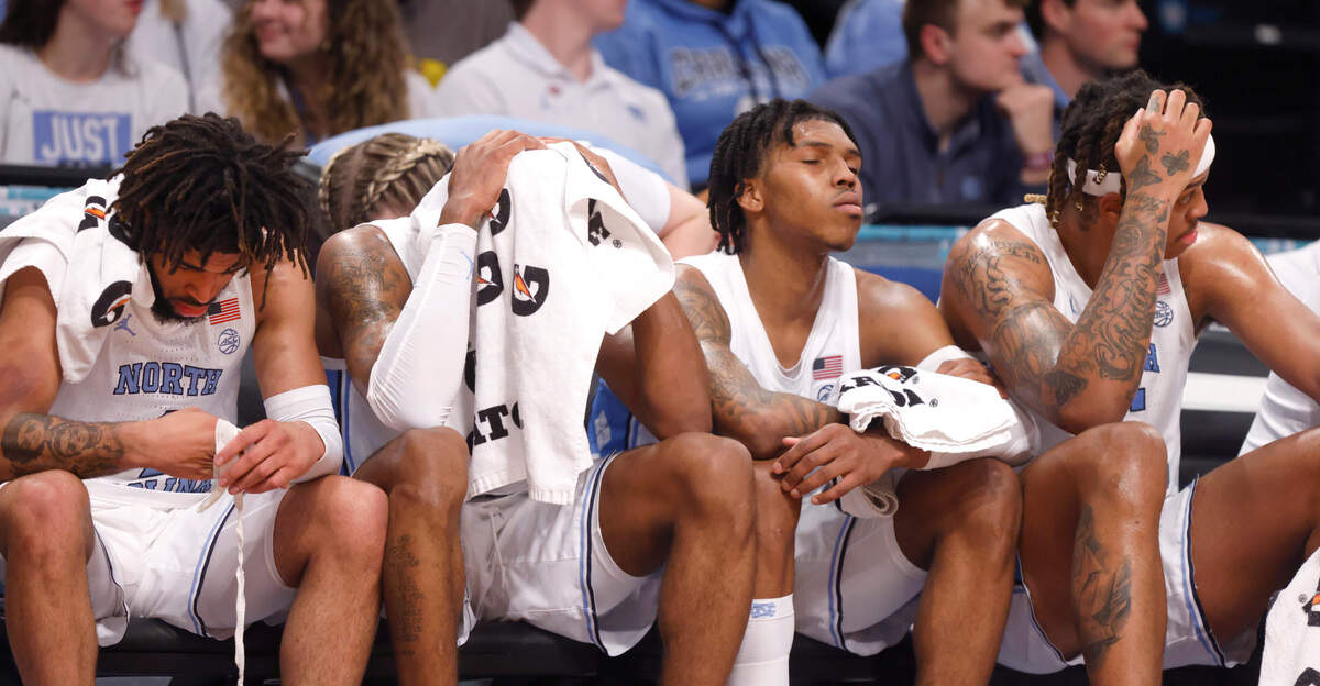 From left North Carolina’s R.J. Davis (4), Leaky Black (1), Caleb Love (2), and Armando Bacot (5) sit on the bench in the final minutes of Virginia Tech’s 72-59 victory over UNC in the semifinals of the ACC men’s basketball tournament at the Barclays Center in Brooklyn, N.Y., Friday, March 11, 2022.