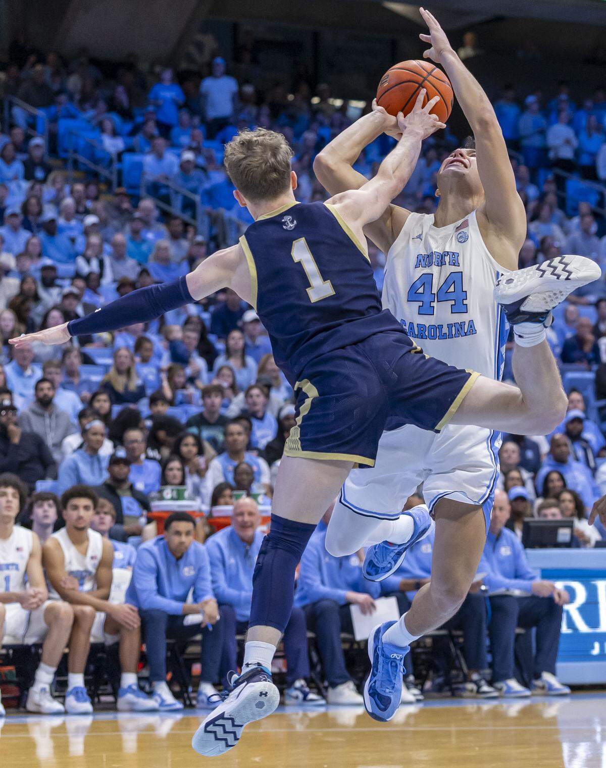 Navy guard Austin Benigni (1) defends North Carolina guard Luka Bogavac (44) in the second half on Tuesday, November 18, 2025 at the Smith Center in Chapel Hill, N.C.
