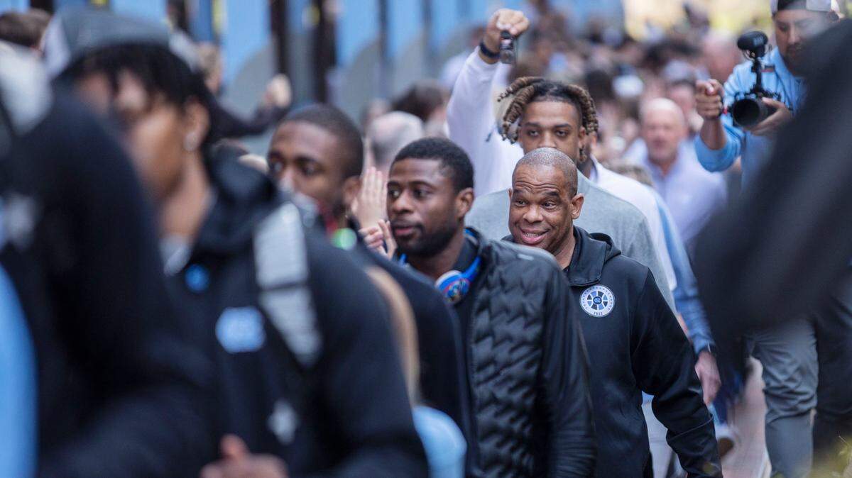 UNC basketball head coach Hubert Davis smiles as his team begins their journey to the Final Four outside the Dean Dome in Chapel Hill, N.C. on Wednesday, March 30, 2022.