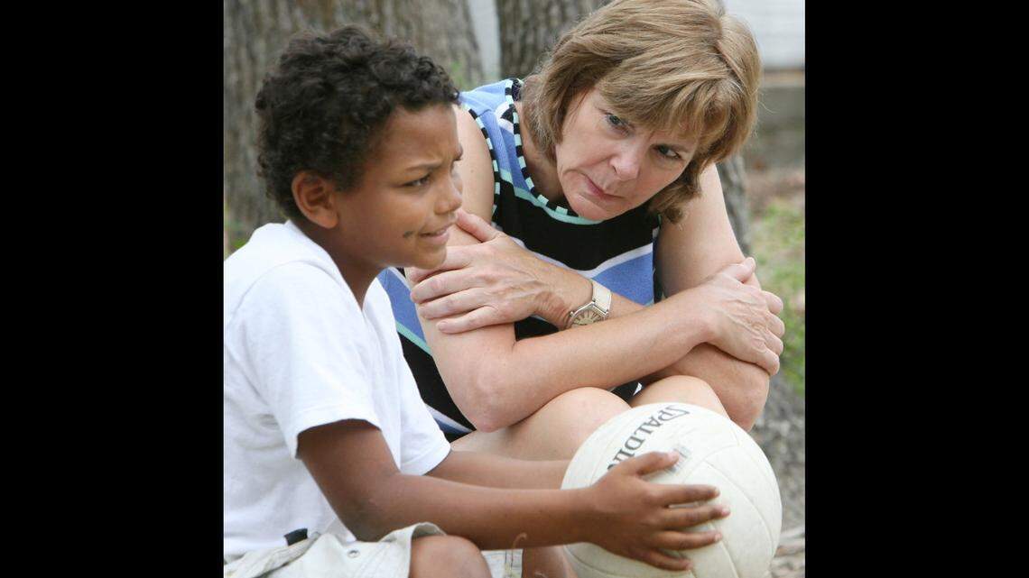 Angelyn Bush, a clinical social worker from Catholic Charities, right, listens as Jace Ladner, 7, of Necaise Crossing, Mississippi, talks about Hurricane Katrina at Camp Noah in June 2006. The camp was an effort to provide children with a way to work through their Katrina experience. A large number of parents are reporting that children are still suffering from mental health issues five years after the storm. (John Fitzhugh/Biloxi Sun Herald/MCT)