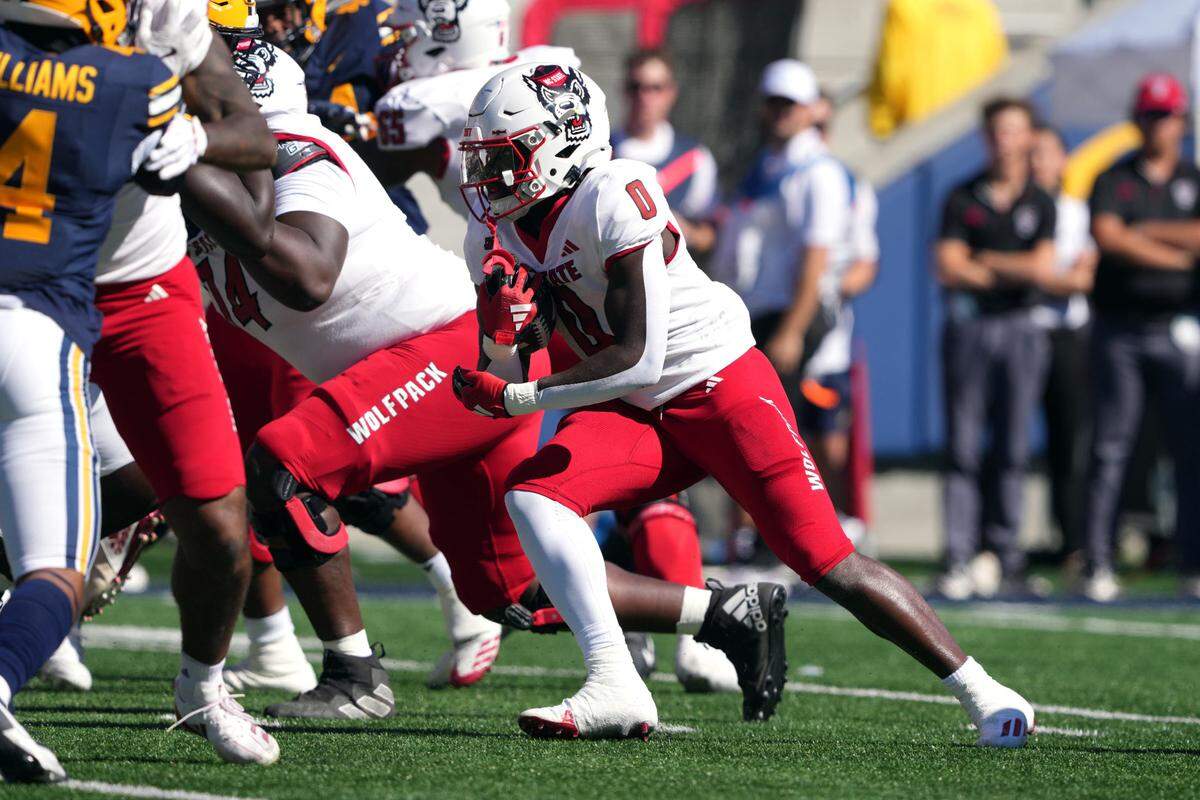 Oct 19, 2024; Berkeley, California, USA; North Carolina State Wolfpack running back Kendrick Raphael (0) carries the ball against the California Golden Bears during the first quarter at California Memorial Stadium. Mandatory Credit: Darren Yamashita-Imagn Images