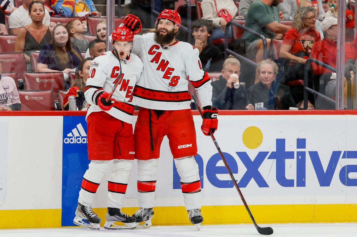 Apr 13, 2023; Sunrise, Florida, USA; Carolina Hurricanes defenseman Brent Burns (8) celebrates with center Sebastian Aho (20) after scoring during the first period against the Florida Panthers at FLA Live Arena. Mandatory Credit: Sam Navarro-USA TODAY Sports