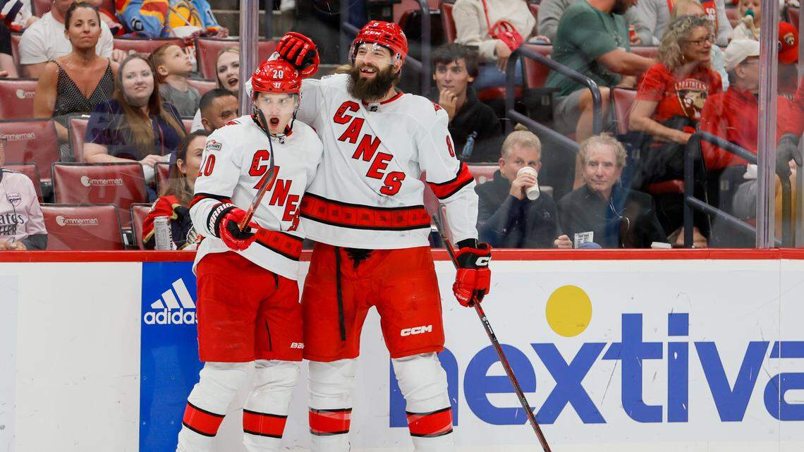 Carolina Hurricanes defenseman Brent Burns (8) celebrates with center Sebastian Aho (20) after scoring during the first period against the Florida Panthers at FLA Live Arena.
