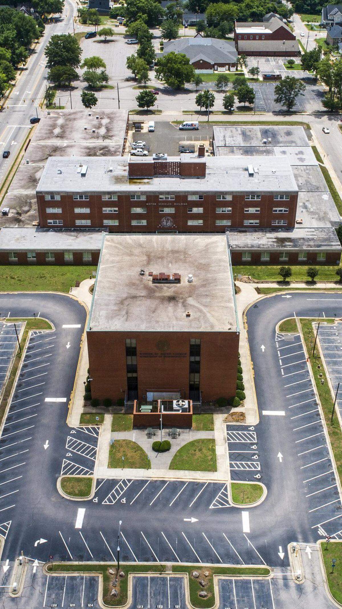 The former North Carolina Division of Motor Vehicles headquarters sits empty at the intersection Tarboro Street and New Bern Avenue east of downtown Raleigh June 11, 2021. After the headquarters was moved to Rocky Mount last fall, private developers and city leaders have expressed interest in the property.