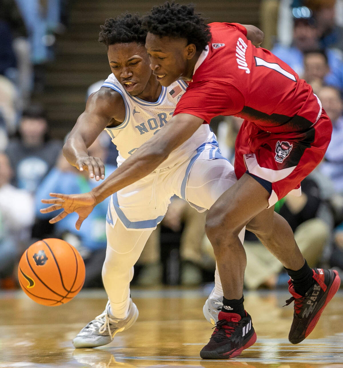 N.C. State’s Jarkel Joiner (1) makes a steal from North Carolina’s D’Marco Dunn (11) during the first half on Saturday, January 21, 2023 at the Smith Center in Chapel Hill, N.C.