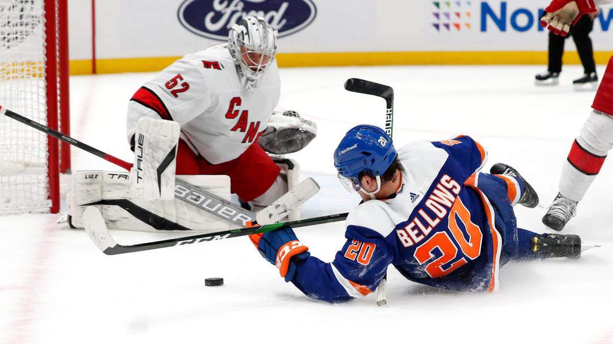 New York Islanders left wing Kieffer Bellows (20) plays the puck against Carolina Hurricanes goaltender Antti Raanta (32) during the second period of an NHL hockey game, Sunday, Apr. 24, 2022, in New York. (AP Photo/Noah K. Murray)