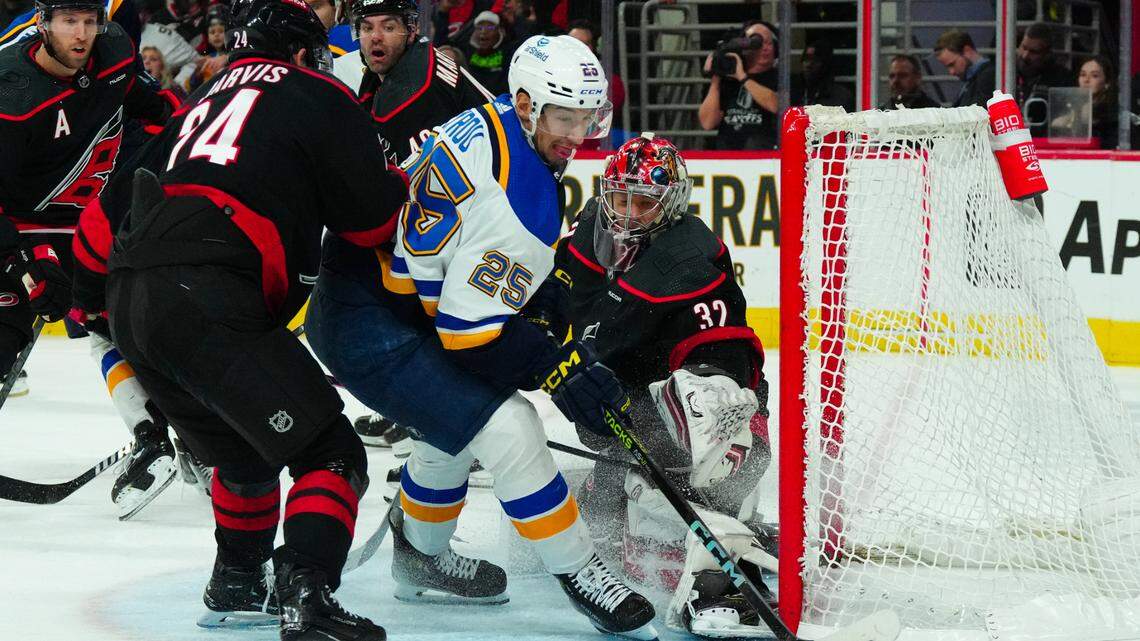Jan 6, 2024; Raleigh, North Carolina, USA; Carolina Hurricanes goaltender Antti Raanta (32) stops the shot attempt by St. Louis Blues center Jordan Kyrou (25) during the second period at PNC Arena. Mandatory Credit: James Guillory-USA TODAY Sports