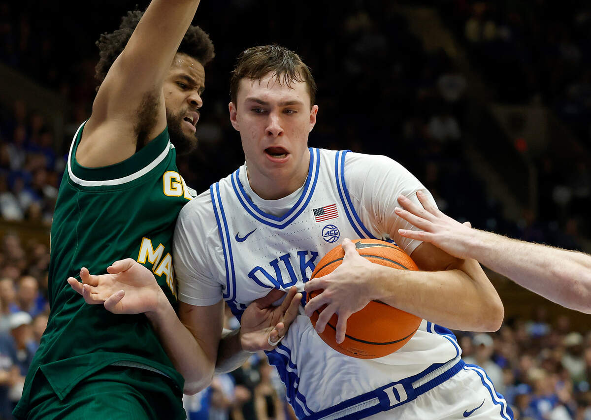 Duke’s Cooper Flagg pushes the ball past George Mason’s Zach Anderson during the second half of the Blue Devils’ 68-47 win on Tuesday, Dec. 17, 2024, at Cameron Indoor Stadium in Durham, N.C.