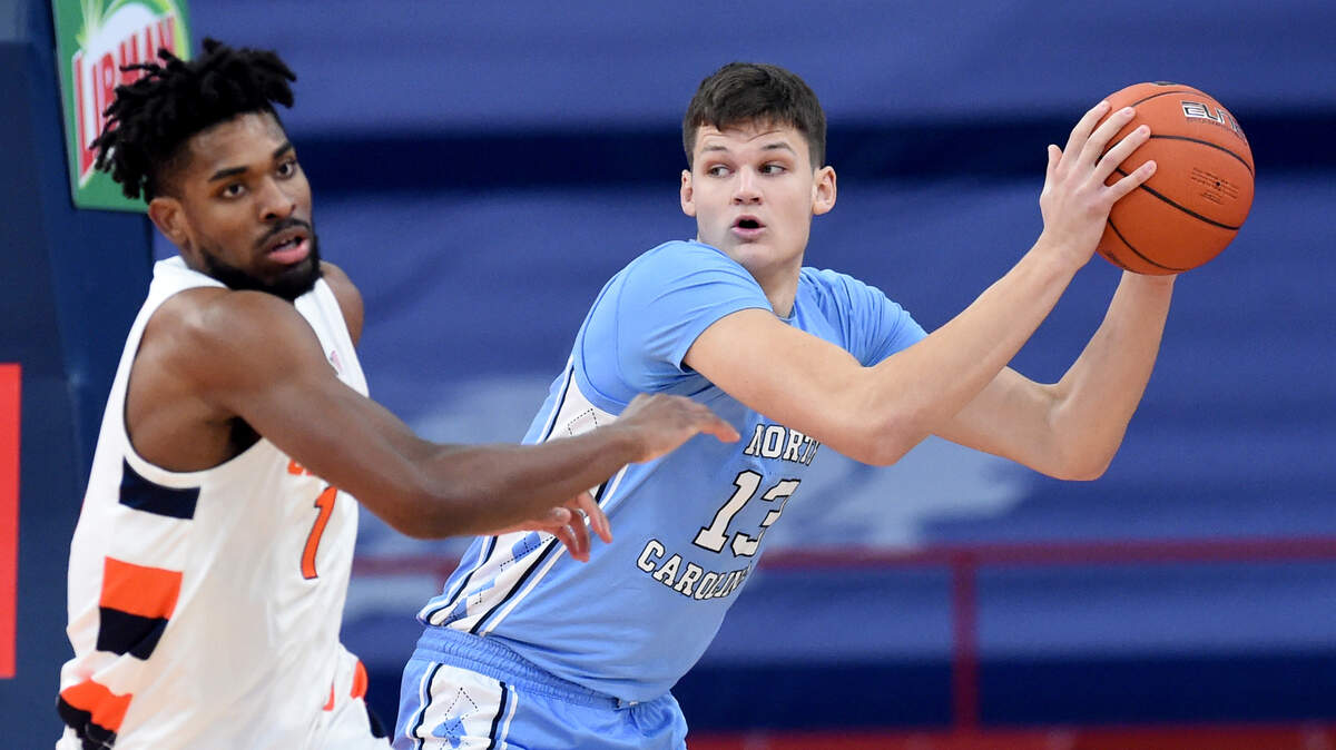 North Carolina Tar Heels forward Walker Kessler (13) pulls down a rebound in front of Syracuse Orange forward Quincy Guerrier (1) in a game between Syracuse and North Carolina at the Carrier Dome in Syracuse N.Y. March 1, 2021.