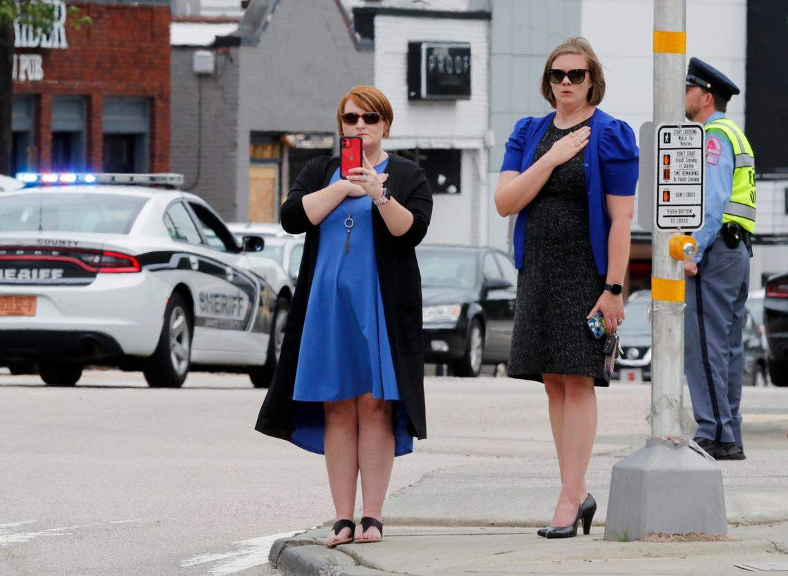 Onlookers watch as a procession for slain Wake County Sheriffs Deputy Ned Byrd comes down Glenwood Avenue past the Five Points neighborhood in Raleigh, N.C., Friday, August 19, 2022.