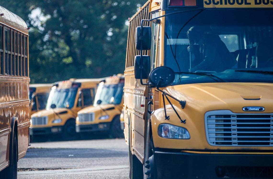 A Wake County school bus driver sweeps their bus in a parking area on Capital Blvd. in Raleigh after completing a morning route Friday, Oct. 29, 2021. An ongoing school bus driver shortage could stall the start of a new after-school math tutoring program for middle school students.