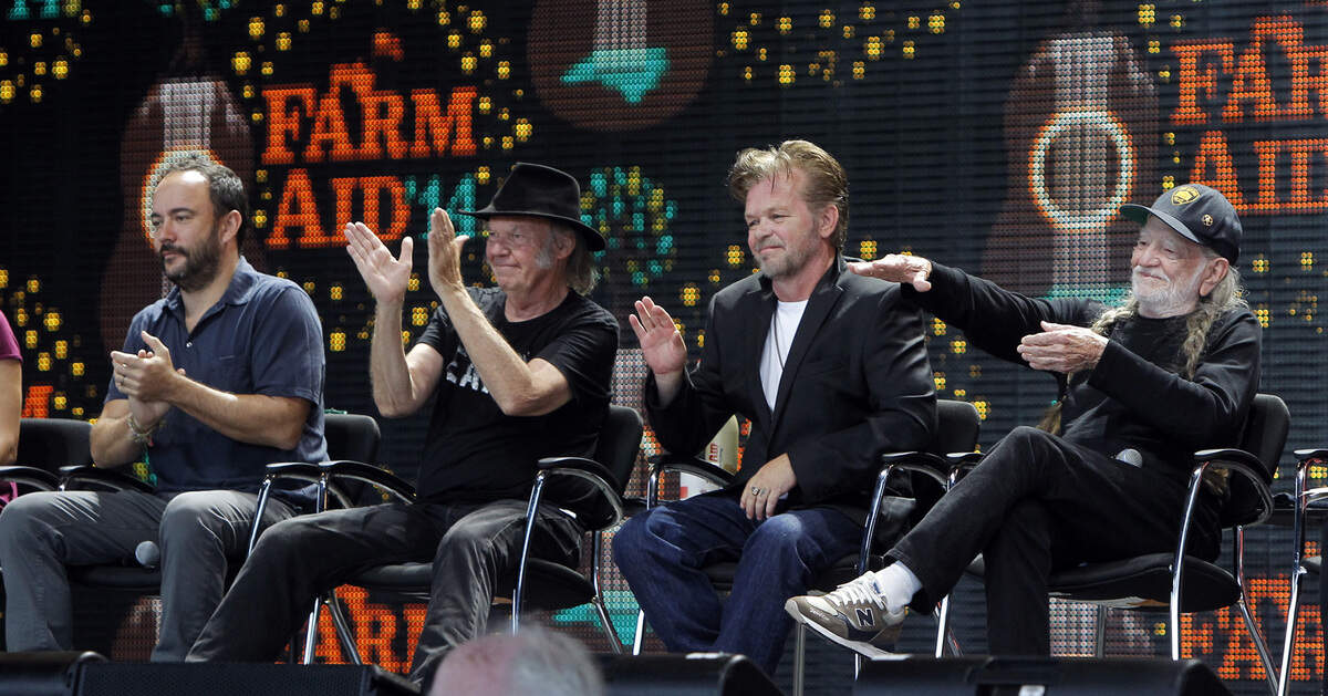 Musicians, from left, Dave Matthews, Neil Young, John Mellencamp and Willie Nelson applaud a farmer during a press conference held before the Farm Aid concert at Walnut Creek Amphitheater in Raleigh in 2014.