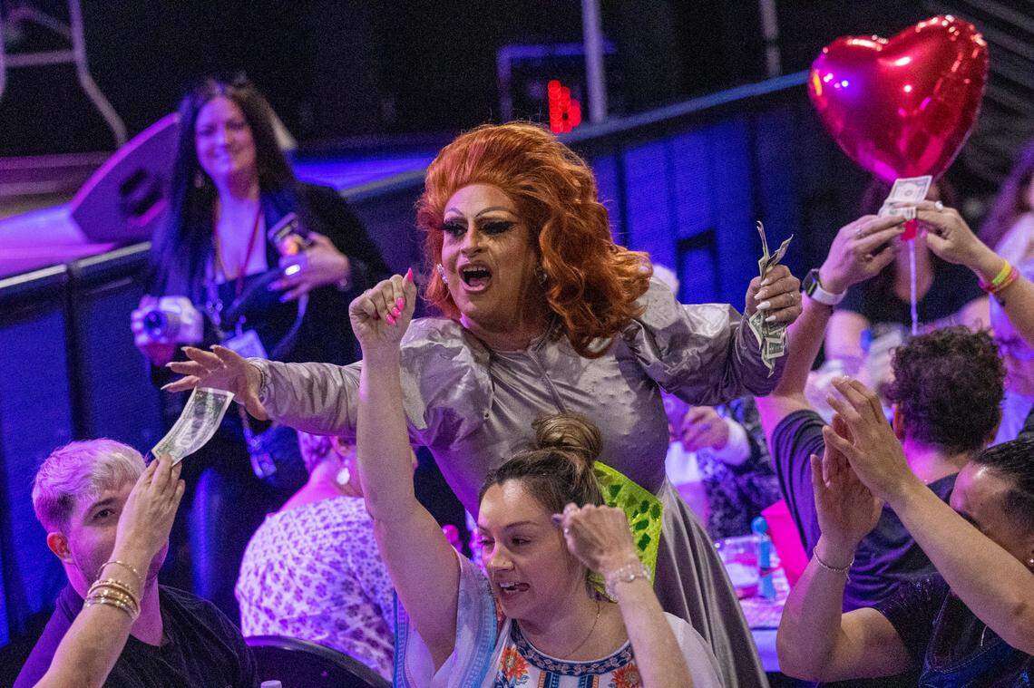 A drag performer collects dollar bills from the audience during North Carolina’s oldest running drag show, Green Queen Bingo, which dates to 2004 and regularly fills Piedmont Hall in Greensboro.