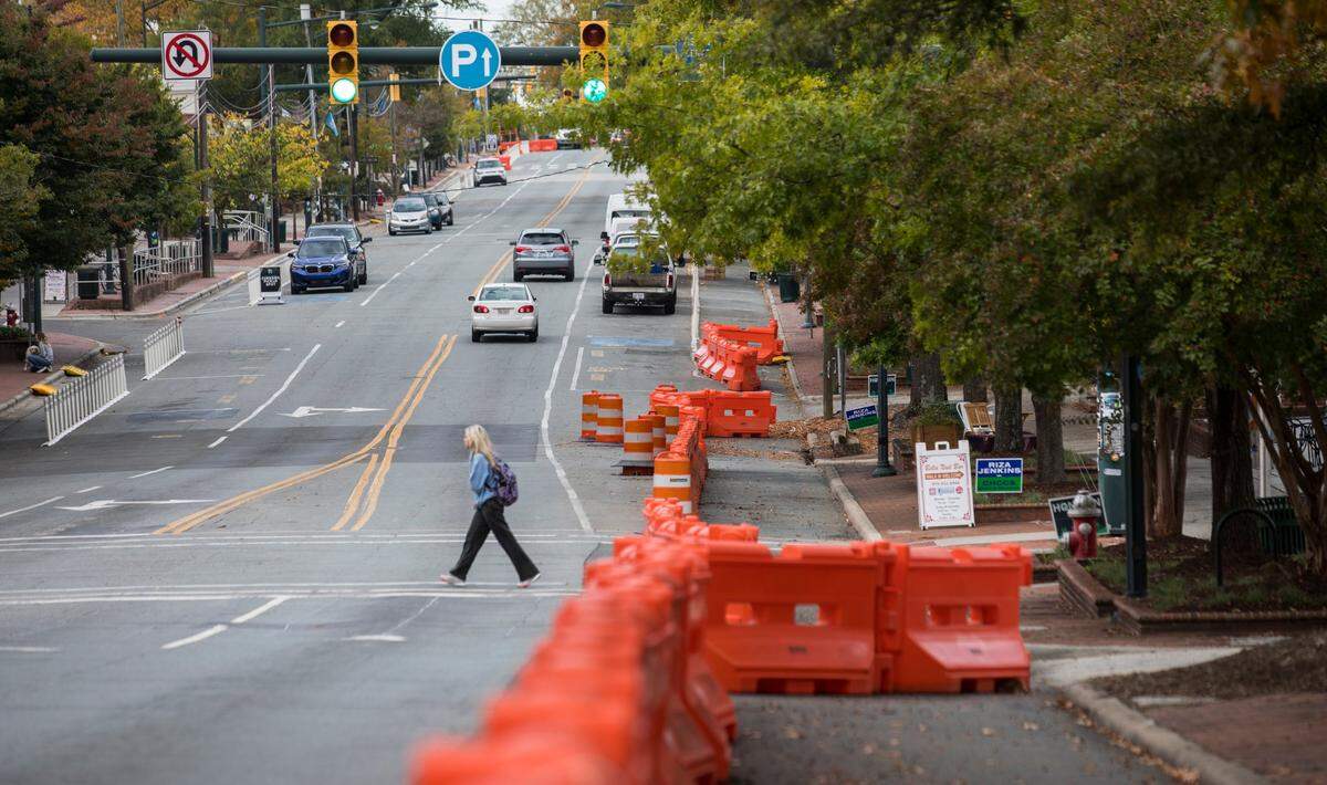 Temporary barriers can be seen throughout Franklin Street in Chapel Hill, N.C., pictured here on Thursday, Oct. 28, 2021. The barriers are meant to widen sidewalk space, formerly parking space, for patrons of downtown businesses and restaurants during the COVID-19 pandemic.