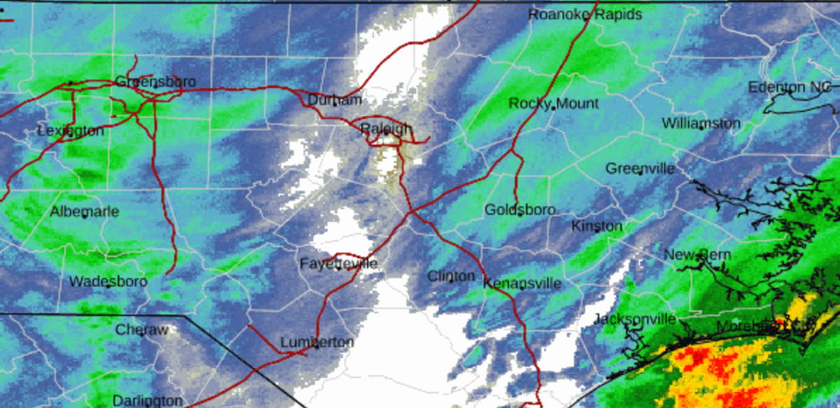 A screenshot of National Weather Service radar at midday Saturday shows Raleigh between two areas of snowfall while the Capital City is a no-snow zone. Forecasters say we’ll get ours when the two incoming weather systems finally collide.