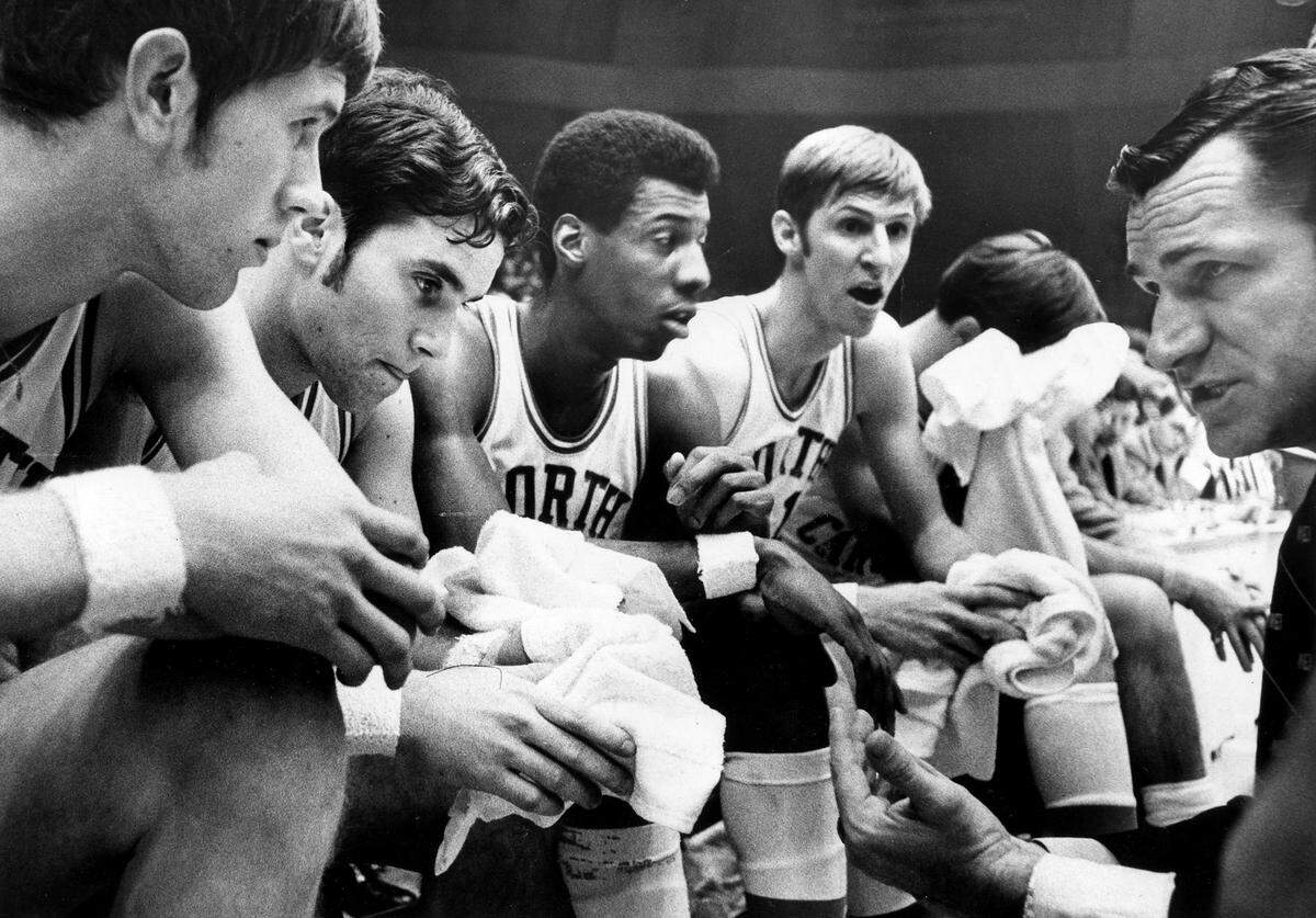 UNC Coach Dean Smith, right, coaches his team, including Eddie Fogler (2nd from left), and Charlie Scott,  during the 1969 ACC Tournament. 