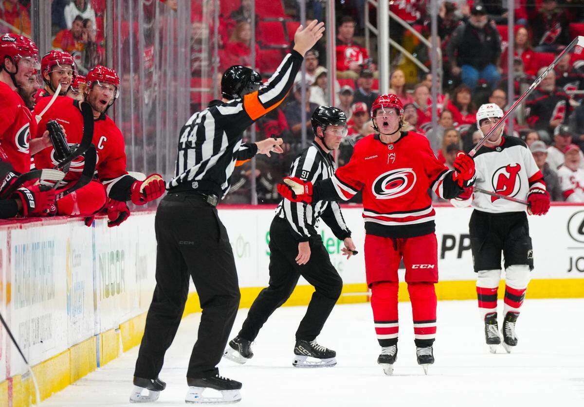 Carolina Hurricanes right wing Jackson Blake (53) and center Jordan Staal (11) react to referee Justin Kea (44) call against the New Jersey Devils during the third period at Lenovo Center. Mandatory Credit: James Guillory-Imagn Images