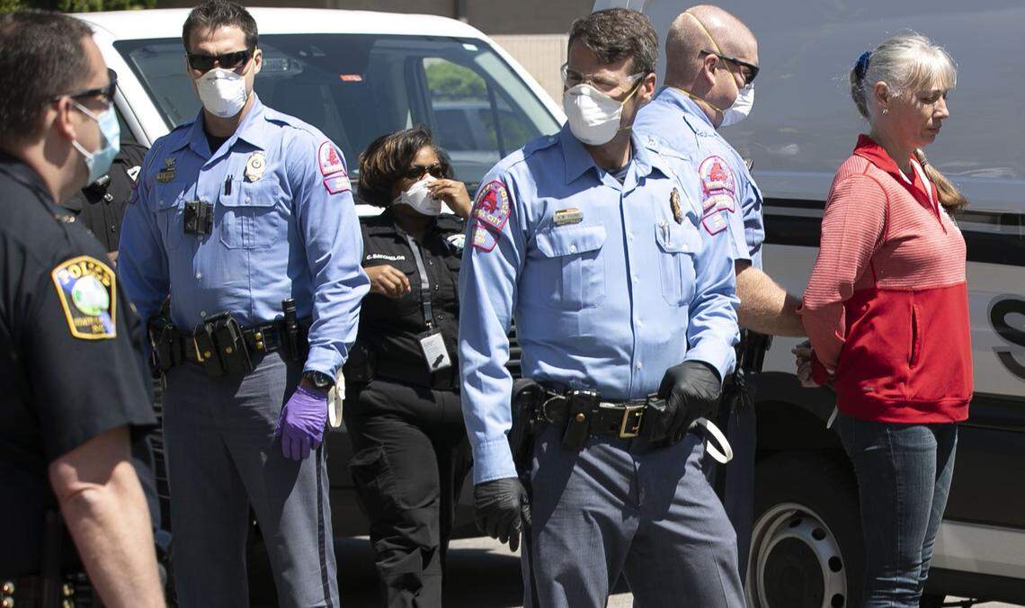 Police arrest a woman after she was told several times to disperse from a gathering of protestors calling on Governor Roy Cooper to re-open North Carolina, amid concerns of the economic fallout from his stay at home order due to the COVID-19 virus. Protestor gathered at the corner of N. Wilmington and Jones Street for nearly two hours before being ordered to disperse on Tuesday, April 14, 2020 in Raleigh, N.C.