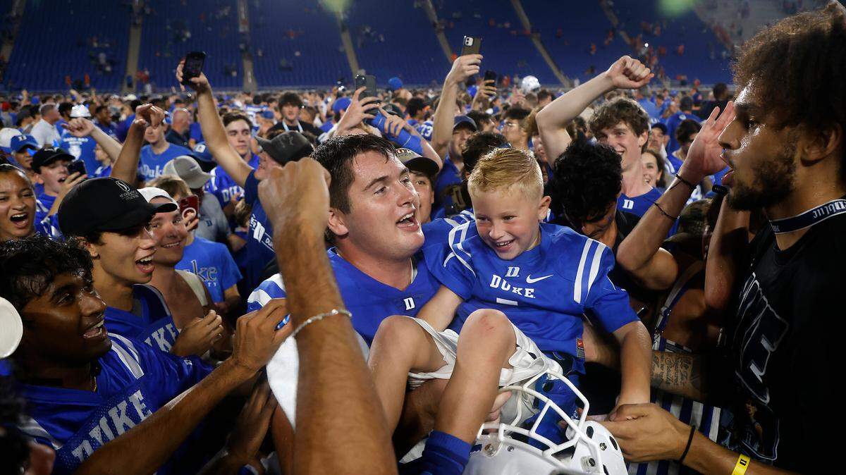 Duke players, students and fans celebrate on the field following the Blue Devils’ 28-7 win over Clemson on Monday, Sept. 4, 2023, at Wallace Wade Stadium in Durham, N.C.