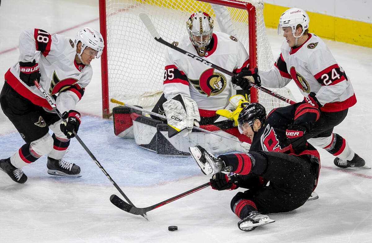 Ottawa’s Tim Stutzle (18) and Jacob Bernard-Docker (24) stop Carolina Hurricanes’ Jesper Fast (71) on a scoring attempt on goalie Leevi Merilainen (35) during the second period on Tuesday, April 4, 2023 at PNC Arena in Raleigh, N.C.