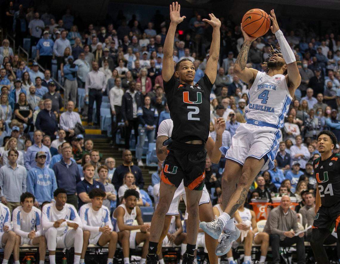 North Carolina’s R.J. Davis (4) drives to the basket against Miami’s Bensely Joseph (4) in the second half on Monday, February 13, 2023 at the Smith Center in Chapel Hill, N.C. Davis lead the Tar Heels with 23 points in their 80-72 loss to Miami.
