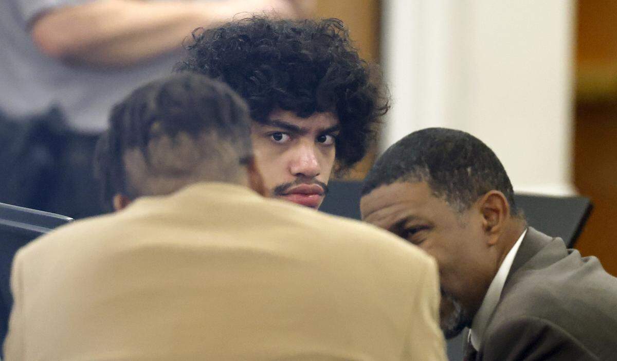 Issiah Ross, who is accused of fatally shooting two teenagers in 2022, listens as his attorneys confer during his trial at the Orange County Courthouse in Hillsborough, N.C. on Wednesday, Jan. 28, 2026.