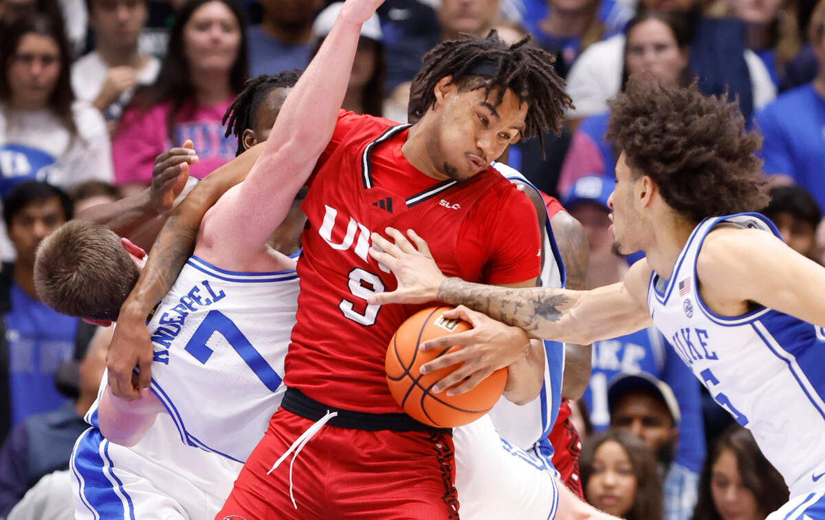 Incarnate Word’s Lamin Sabally (9) pulls in the rebound from Duke’s Kon Knueppel (7) and Tyrese Proctor (5) during the first half of Duke’s game against Incarnate Word at Cameron Indoor Stadium in Durham, N.C., Tuesday, Dec. 10, 2024.