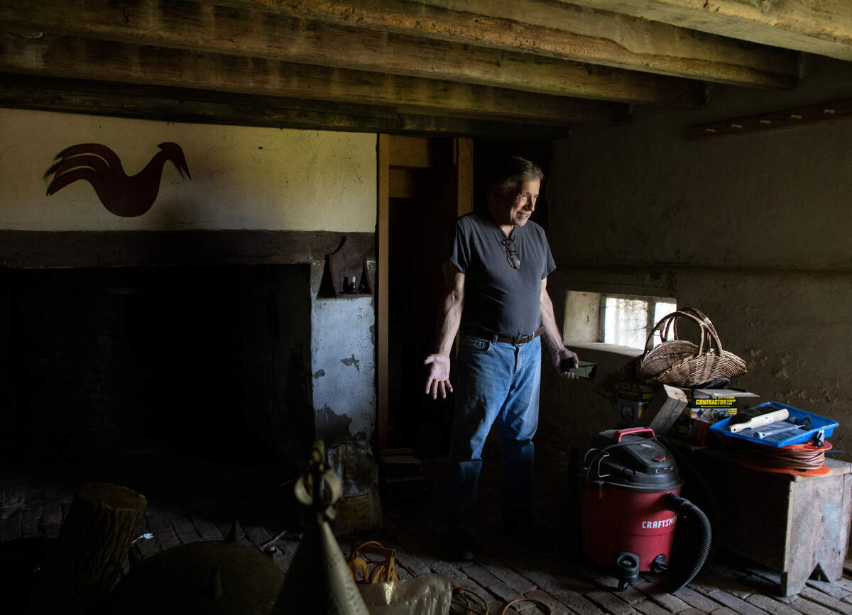 Bob Tucci smiles as he stands in the winter kitchen of the Duke-Lawrence House near Rich Square, N.C., on June 15, 2022. Tucci is restoring the home, one of the oldest in North Carolina.