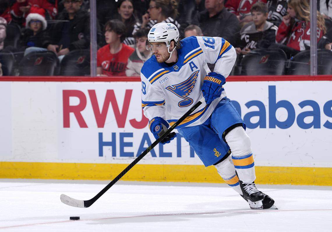 Robert Thomas of the St. Louis Blues controls the puck during overtime against the New Jersey Devils at Prudential Center on Nov. 26, 2025 in Newark, New Jersey.