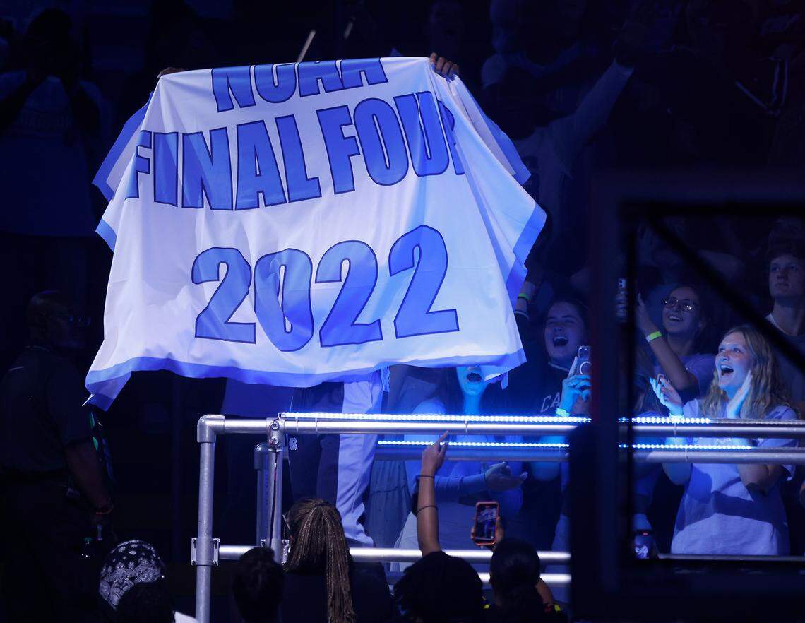 North Carolina’s Leaky Black holds up a 2022 Final Four banner after being introduced during “Live Action with Carolina Basketball” at the Dean E. Smith Center on Friday, Oct. 7, 2022, in Chapel Hill, N.C.