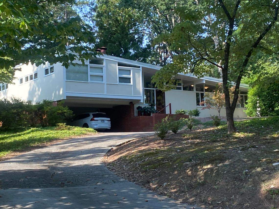 George Matsumoto’s modernist house on Transylvania Avenue as it appears in 2023, shortly before demolition. Orange construction fencing lines the street.