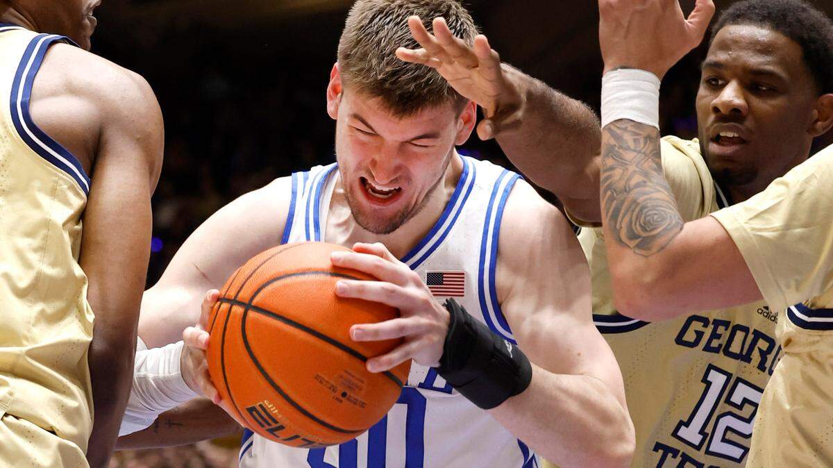 Duke’s Kyle Filipowski (30) is defended by Georgia Tech’s Tyzhaun Claude (12), right, and Tafara Gapare (5) during the first half of Duke’s game against Georgia Tech at Cameron Indoor Stadium in Durham, N.C., Saturday, Jan. 13, 2024.